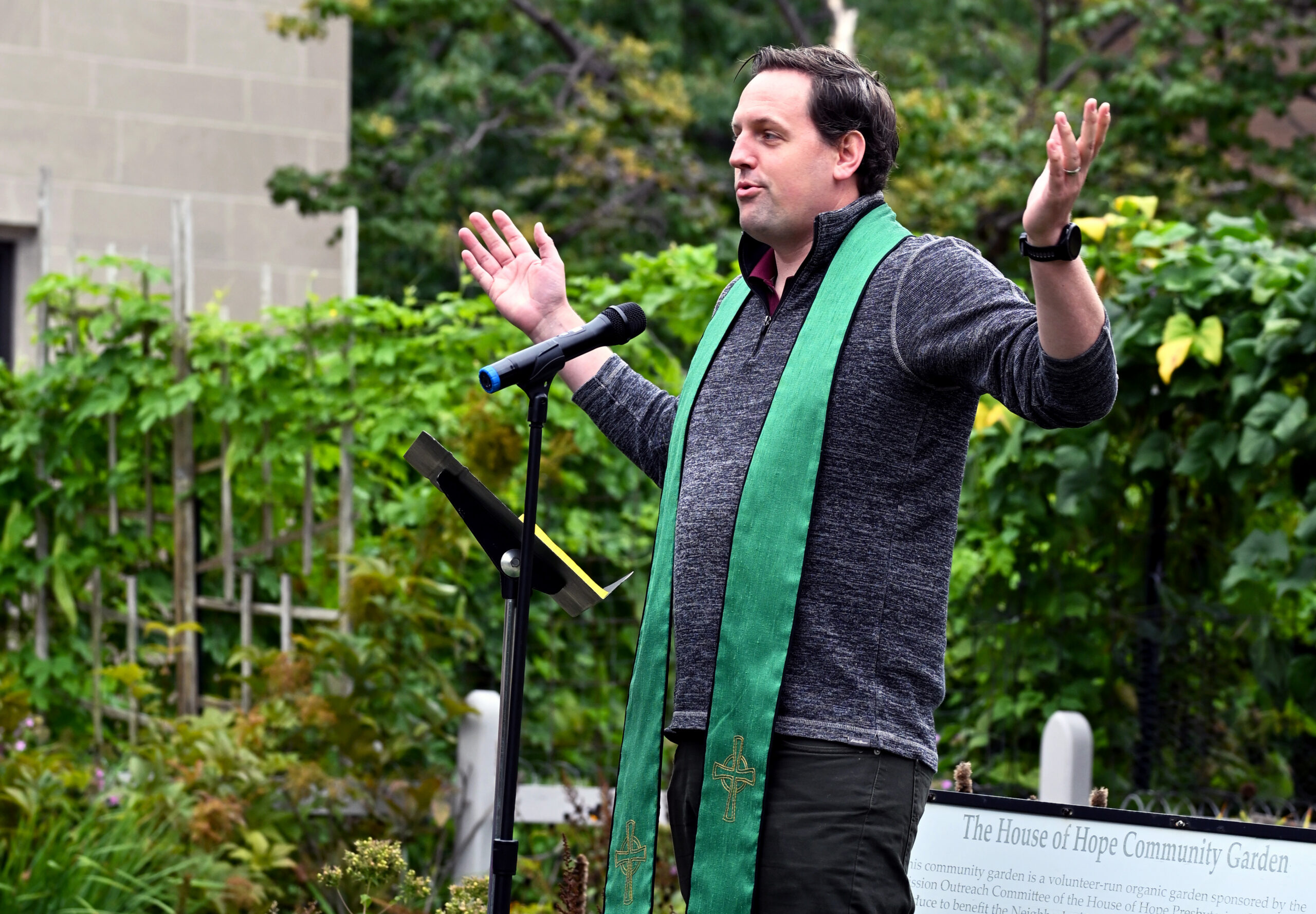 Rev. Jim Cochrane welcomes the community during the Peace Pole commissioning.