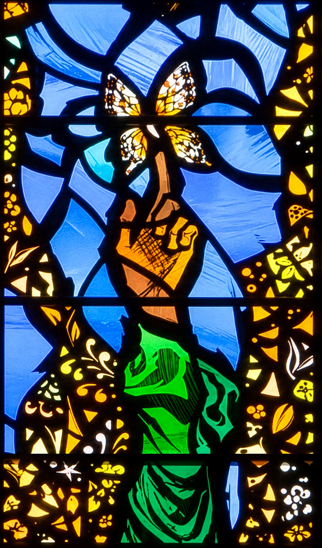 Gold and white butterfly in blue stained glass