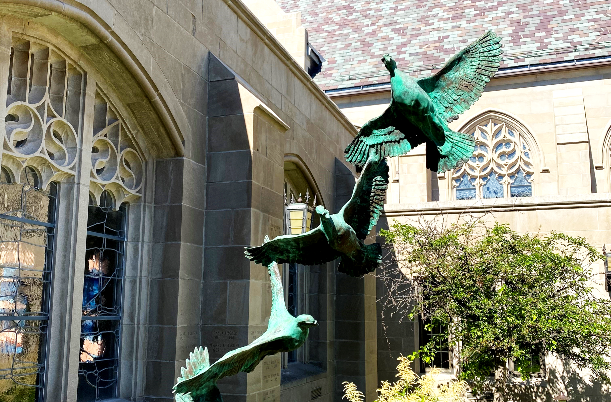 Bronze doves with outstretched wings outside House of Hope.